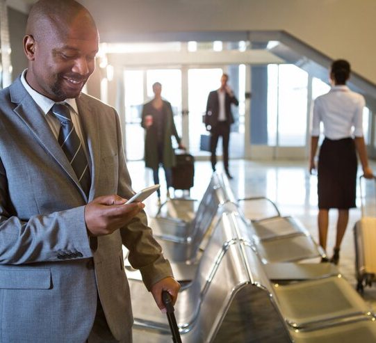 businessman-using-mobile-phone-waiting-area_107420-85122