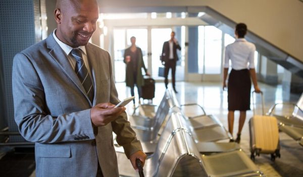 businessman-using-mobile-phone-waiting-area_107420-85122