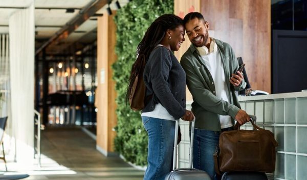 young-african-american-couple-checks-hotel-lobby-excited-vacation-getaway_1192423-3487